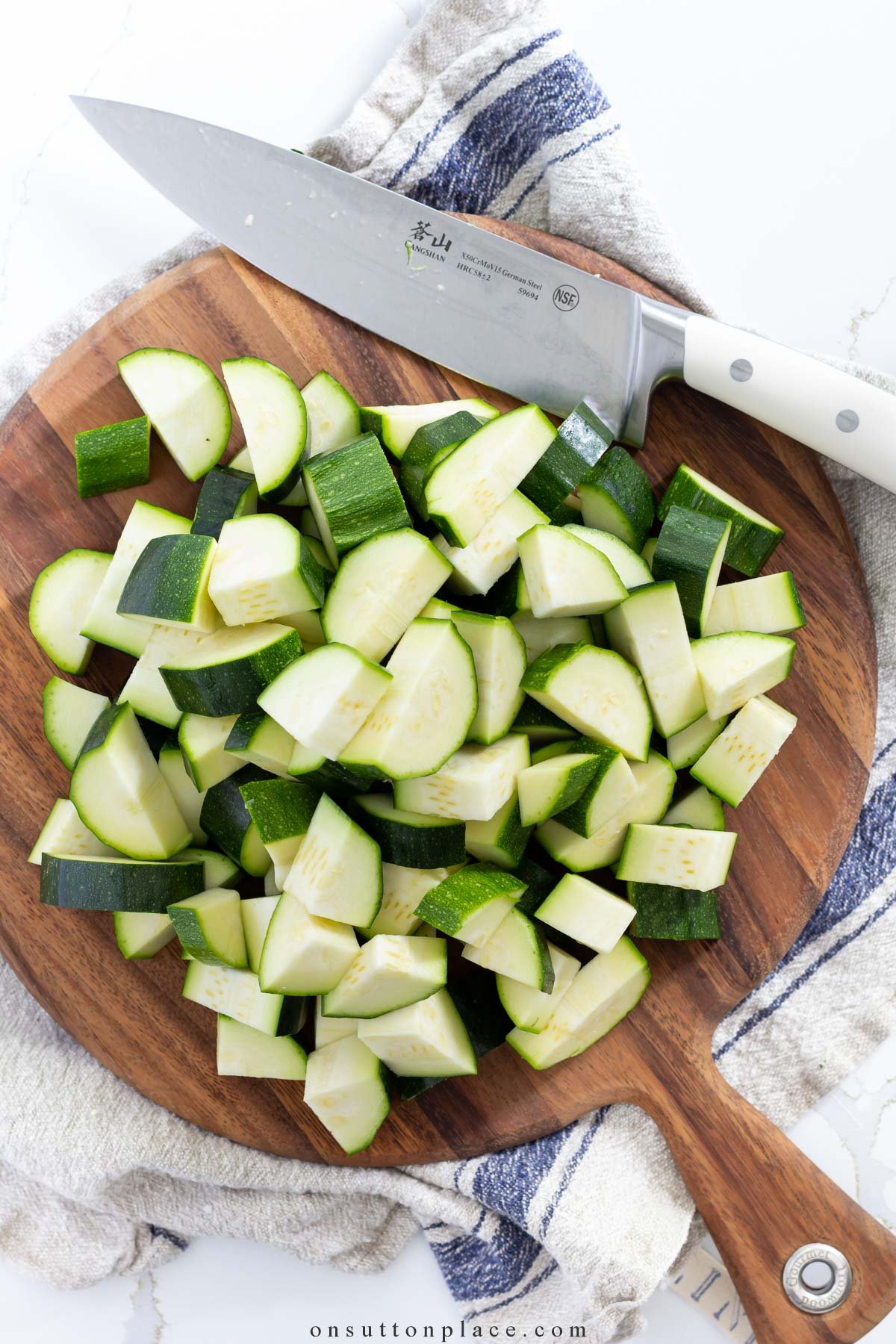 A person preparing zucchini for freezing.